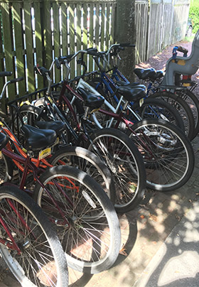 Assortment of adult and child bikes on bike rack